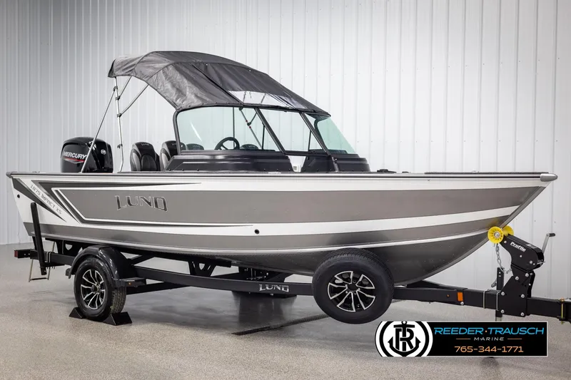 Slide: The Image of 2025 Lund 1875 Impact XS boat on trailer in showroom. - 3