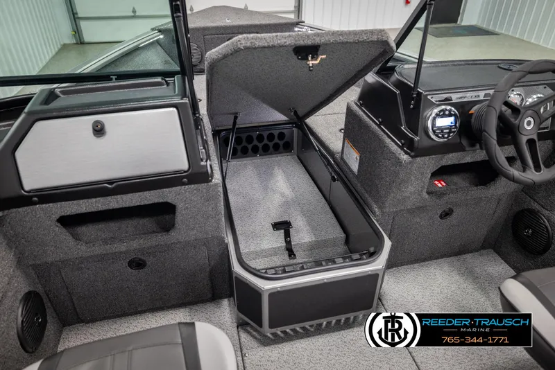 Slide: The Image of 2025 Lund 1875 Impact XS boat interior with open storage compartment and dashboard view. - 31