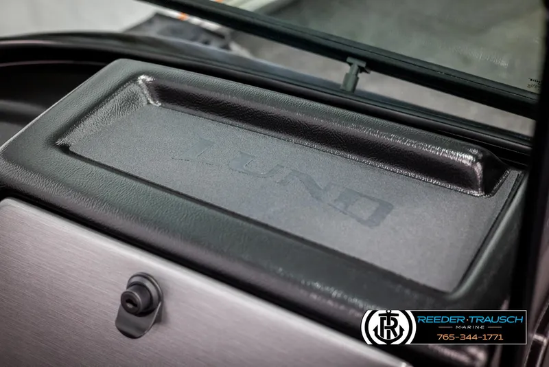 Slide: The Image of 2025 Lund 1875 Impact XS dashboard detail with logo and storage compartment. - 34