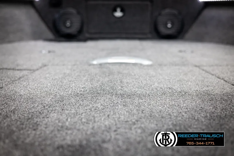 Slide: The Image of 2025 Lund 1875 Impact XS boat interior with carpeted flooring and speakers. - 38