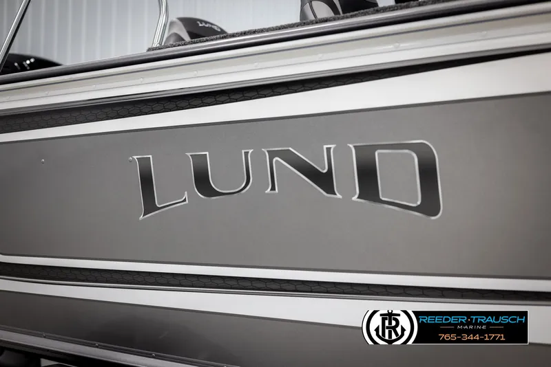Slide: The Image of 2025 Lund 1875 Impact XS boat side view with logo and dealership contact. - 43