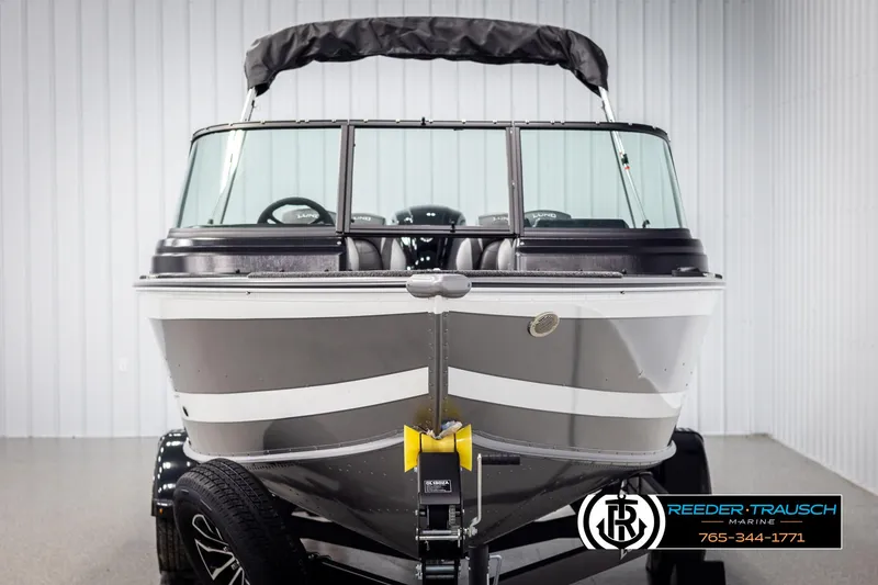 Slide: The Image of 2025 Lund 1875 Impact XS boat, front view, in showroom setting. - 7