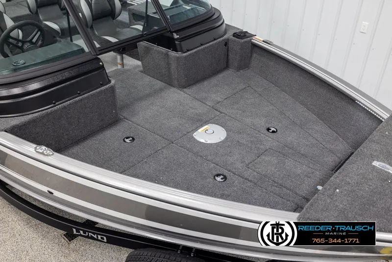 Slide: The Image of 2025 Lund 1875 Impact XS boat interior with gray carpet and seating. - 8