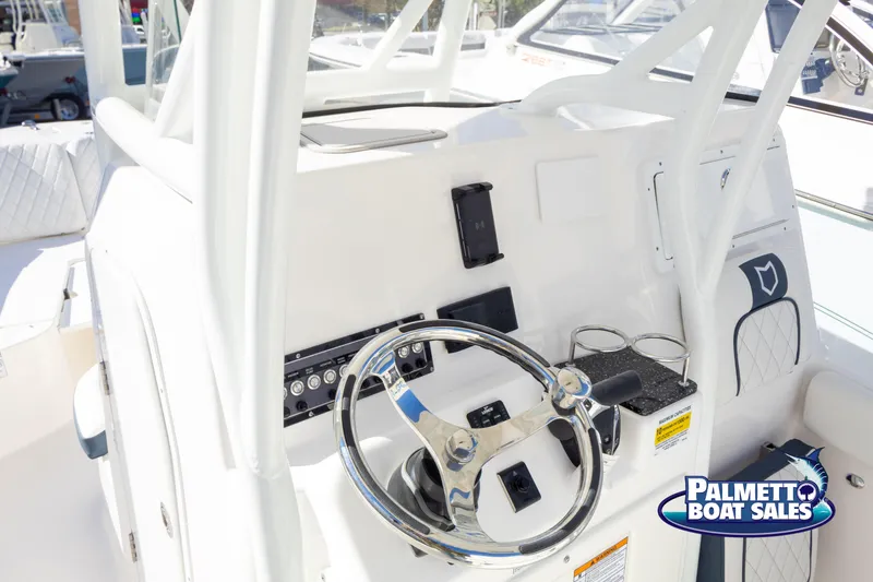 Slide: The Image of 2025 Sea Fox 248 Side Console boat dashboard with steering wheel and controls. - 11