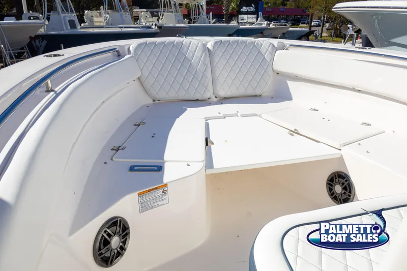 Slide: The Image of 2025 Sea Fox 248 Side Console boat interior with white seating and speakers. - 14