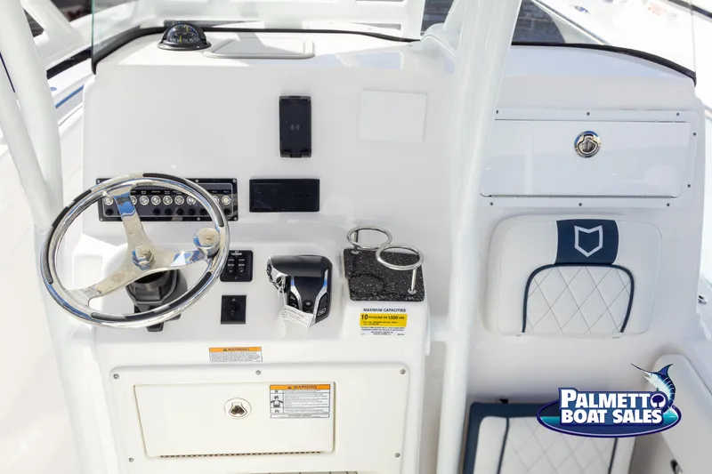 Slide: The Image of 2025 Sea Fox 248 Side Console boat dashboard with steering wheel and controls. - 18