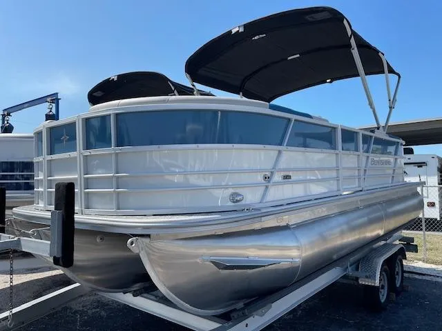 The Image of 2025 Berkshire 22 RFX LE Tri-toon Pontoon boat on trailer, featuring sleek design and canopy. - 1