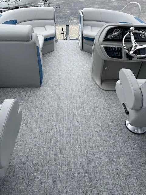 Slide: The Image of Interior of 2025 Berkshire 22 RFX LE Tri-toon Pontoon with gray seating and steering console. - 18