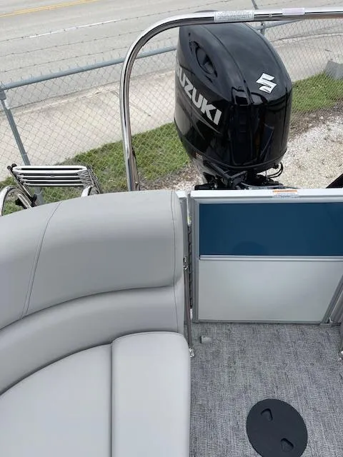 Slide: The Image of 2025 Berkshire 22 RFX LE Tri-toon Pontoon with Suzuki outboard motor, gray seating, and carpeted deck. - 20