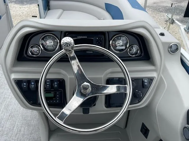 Slide: The Image of Steering console of 2025 Berkshire 22 RFX LE Tri-toon Pontoon with gauges and controls. - 21
