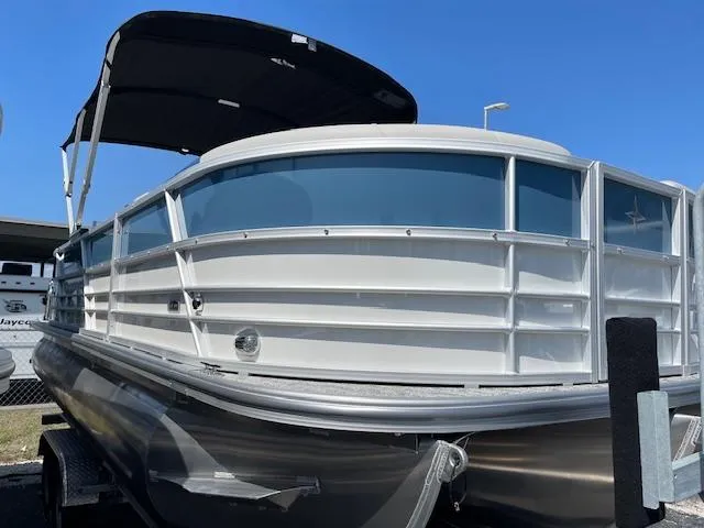 Slide: The Image of 2025 Berkshire 22 RFX LE Tri-toon Pontoon with canopy, docked under clear blue sky. - 3