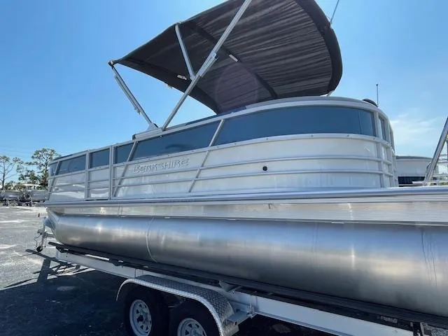 Slide: The Image of 2025 Berkshire 22 RFX LE Tri-toon Pontoon on trailer, featuring sleek design and canopy. - 4