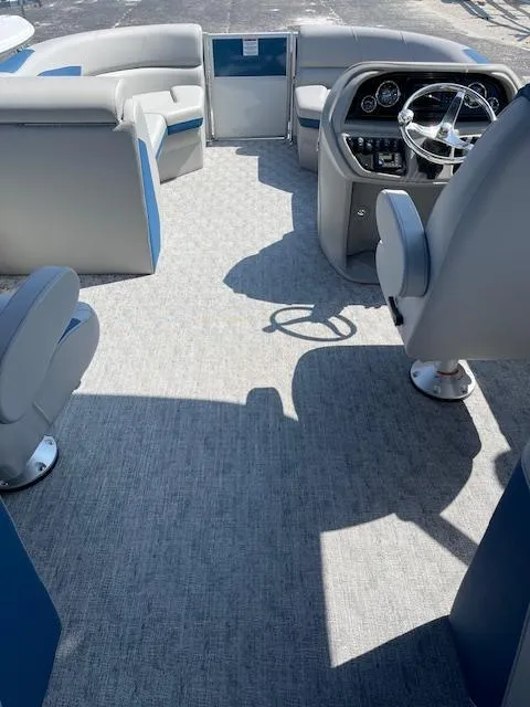 Slide: The Image of 2025 Berkshire 22 RFX LE Tri-toon Pontoon interior with modern seating and steering console. - 5