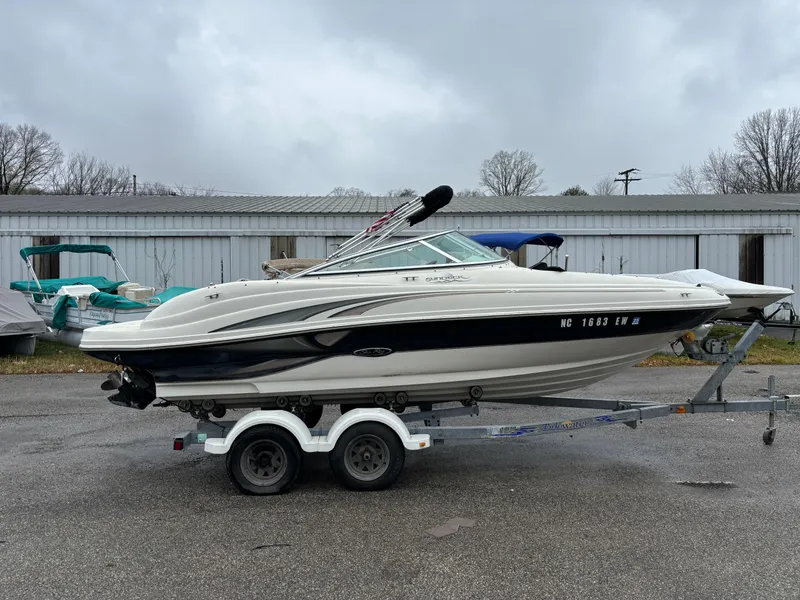 Slide: The Image of 2004 Sea Ray 200 Sundeck boat on trailer, parked outdoors. - 3