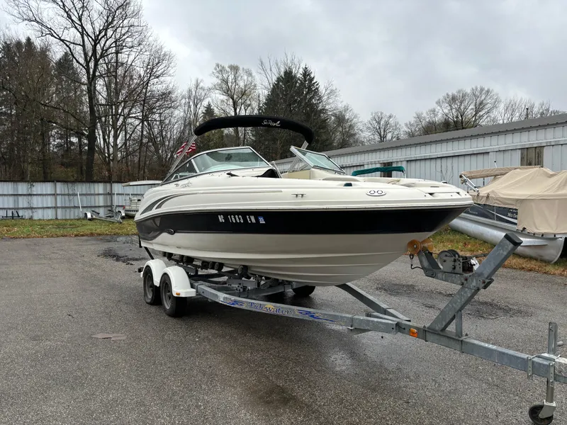 Slide: The Image of 2004 Sea Ray 200 Sundeck boat on trailer, parked outdoors. - 4