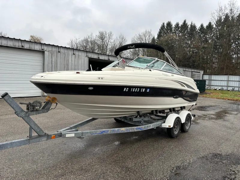 Slide: The Image of 2004 Sea Ray 200 Sundeck boat on trailer, parked outdoors. - 5