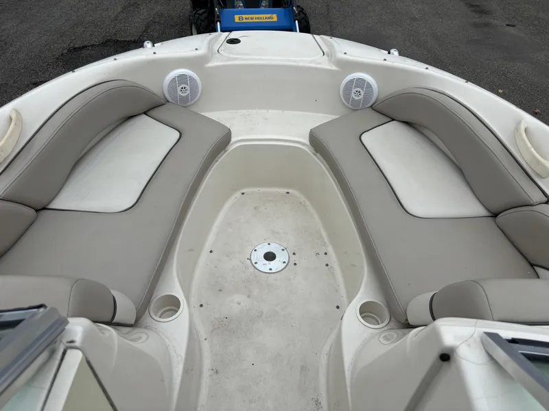 Slide: The Image of 2004 Sea Ray 200 Sundeck boat interior with beige seating and speakers. - 7