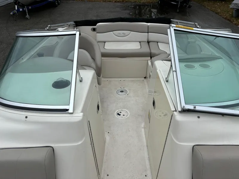 Slide: The Image of 2004 Sea Ray 200 Sundeck interior with seating and windshield. - 8