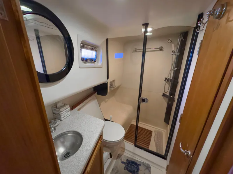 Slide: The Image of 2005 Mainship 34 Trawler bathroom with shower, sink, and toilet. - 24
