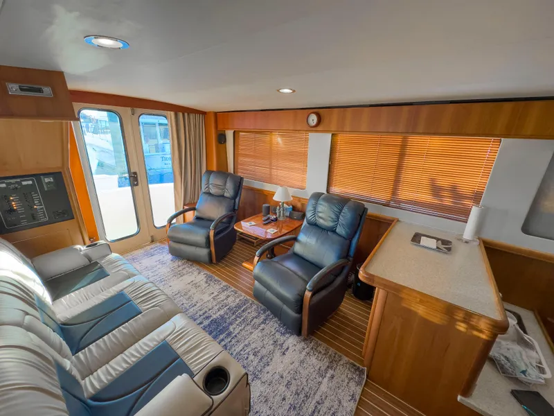 Slide: The Image of Interior of 2005 Mainship 34 Trawler with leather seating and wooden accents. - 28