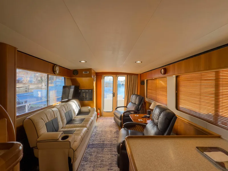 Slide: The Image of Luxurious interior of 2005 Mainship 34 Trawler with leather seating and large windows. - 29