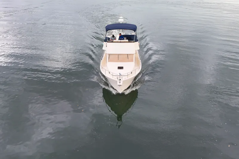 Slide: The Image of 2005 Mainship 34 Trawler cruising on calm water, aerial view. - 3