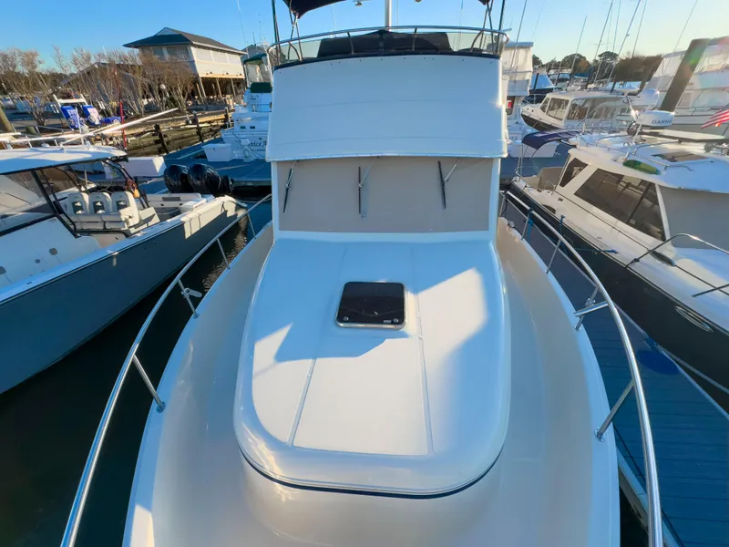 Slide: The Image of 2005 Mainship 34 Trawler docked among other boats in a marina. - 33