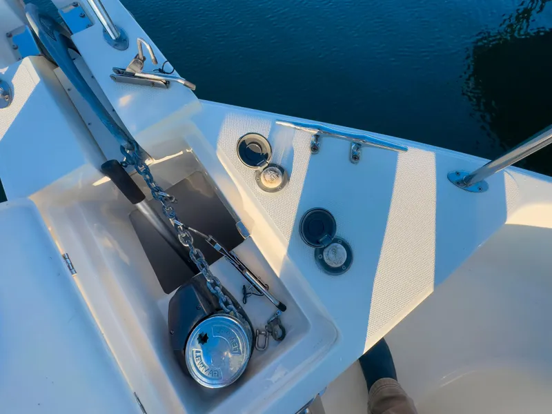 Slide: The Image of Anchor system on 2005 Mainship 34 Trawler, docked on calm water. - 36