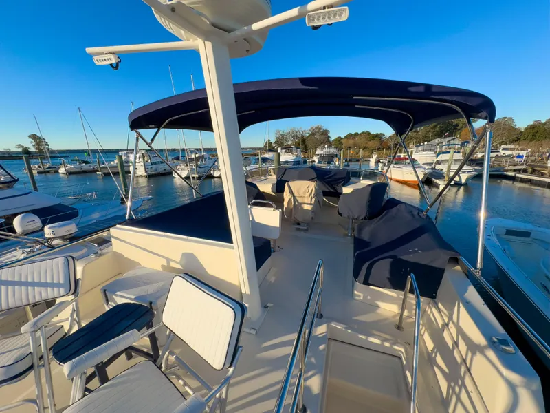 Slide: The Image of 2005 Mainship 34 Trawler docked at marina under clear blue sky. - 39