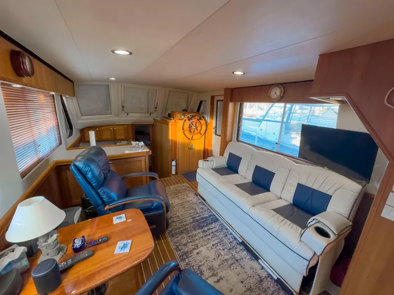 Slide: The Image of Interior of 2005 Mainship 34 Trawler with cozy seating and nautical decor. - 4