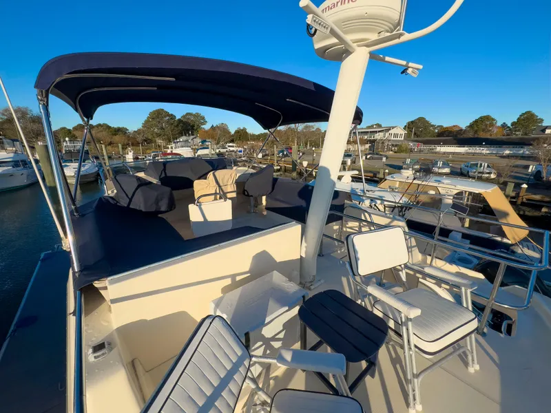 Slide: The Image of 2005 Mainship 34 Trawler with spacious deck and seating, docked at marina. - 40