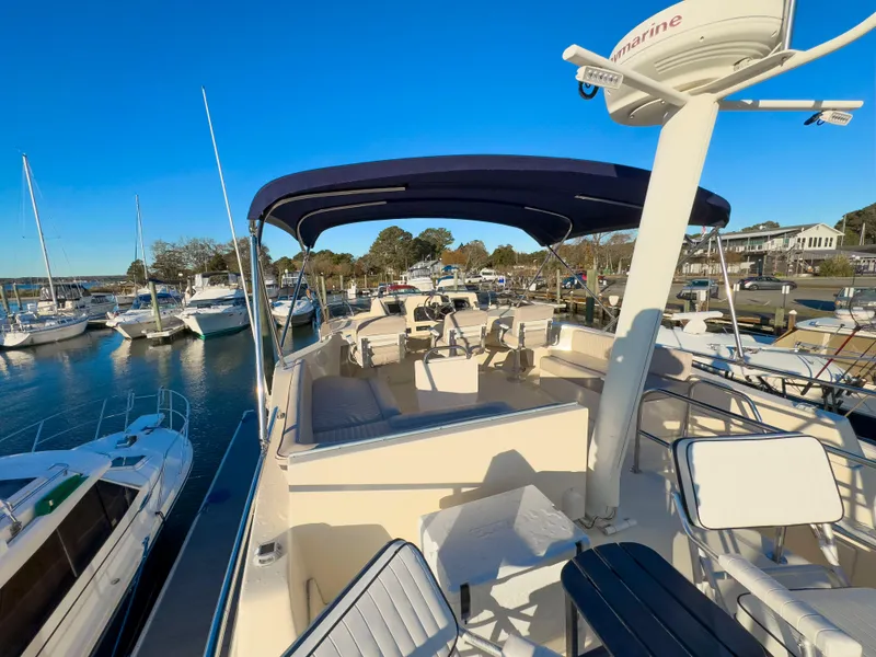 Slide: The Image of 2005 Mainship 34 Trawler docked at marina under clear blue sky. - 44