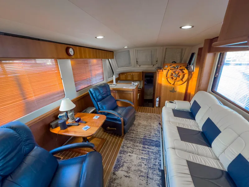 Slide: The Image of Interior of 2005 Mainship 34 Trawler with plush seating and wooden accents. - 5