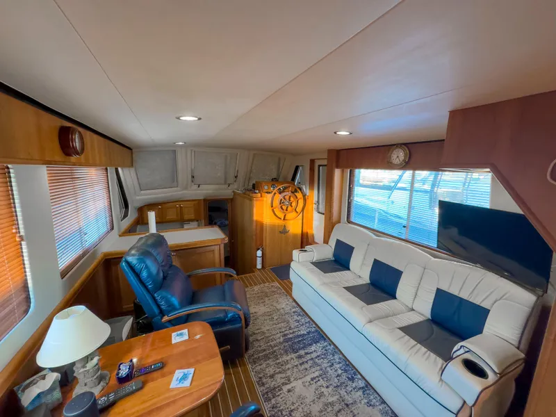 Slide: The Image of Interior of 2005 Mainship 34 Trawler with cozy seating and nautical decor. - 6