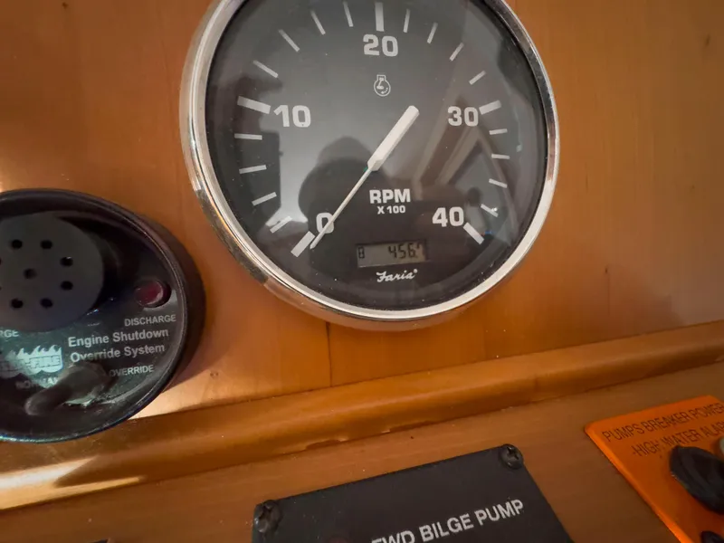 Slide: The Image of RPM gauge and controls on 2005 Mainship 34 Trawler dashboard. - 9