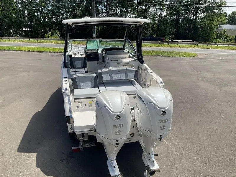 Slide: The Image of 2025 Chaparral 310 OSX boat with dual Yamaha 300 V6 engines, parked outdoors. - 17