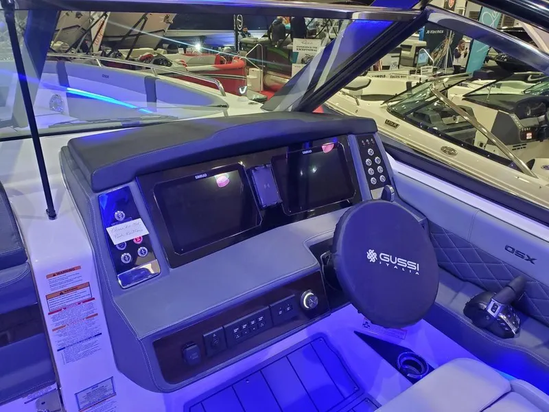 Slide: The Image of 2025 Chaparral 310 OSX boat dashboard with advanced controls and dual displays. - 24