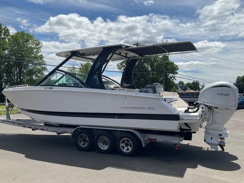 Slide: The Image of 2025 Chaparral 310 OSX boat on trailer under blue sky. - 3