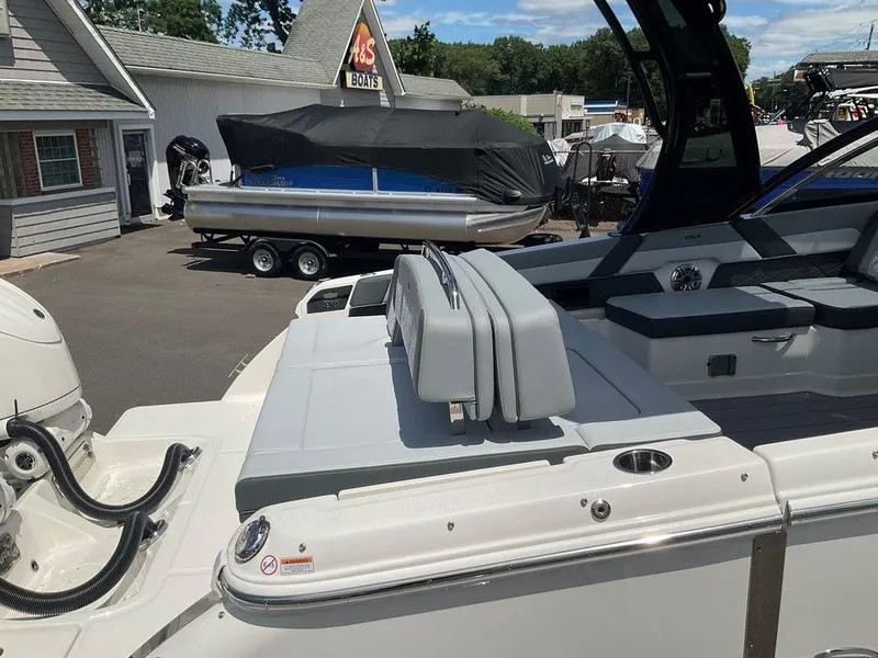 Slide: The Image of 2025 Chaparral 310 OSX boat at a dealership, featuring sleek seating and modern design. - 30