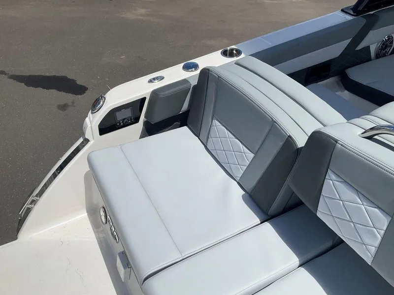 Slide: The Image of 2025 Chaparral 310 OSX boat interior with gray cushioned seating and modern design. - 36
