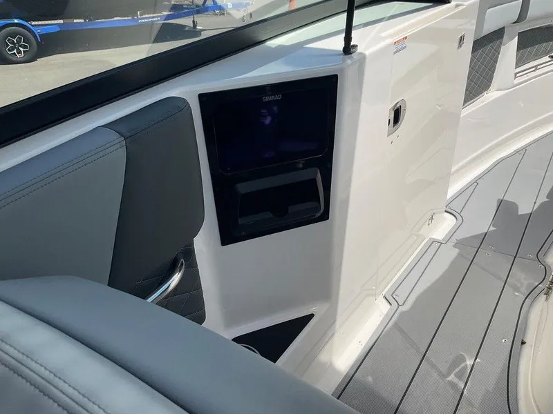 Slide: The Image of Interior view of 2025 Chaparral 310 OSX boat with modern dashboard and seating. - 40