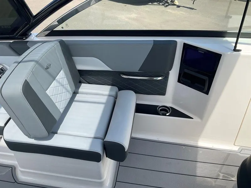 Slide: The Image of 2025 Chaparral 310 OSX interior with sleek gray seating and modern design elements. - 42