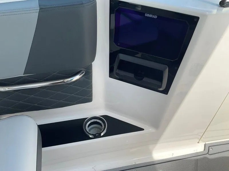 Slide: The Image of Interior of 2025 Chaparral 310 OSX boat with Simrad display and cup holder. - 45