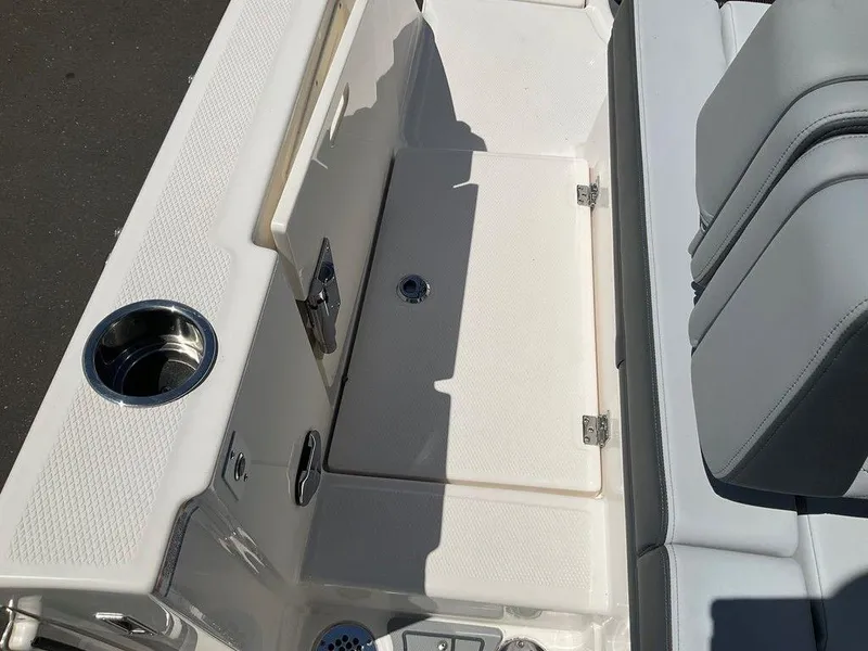 Slide: The Image of 2025 Chaparral 310 OSX boat interior with seating and cup holder. - 48