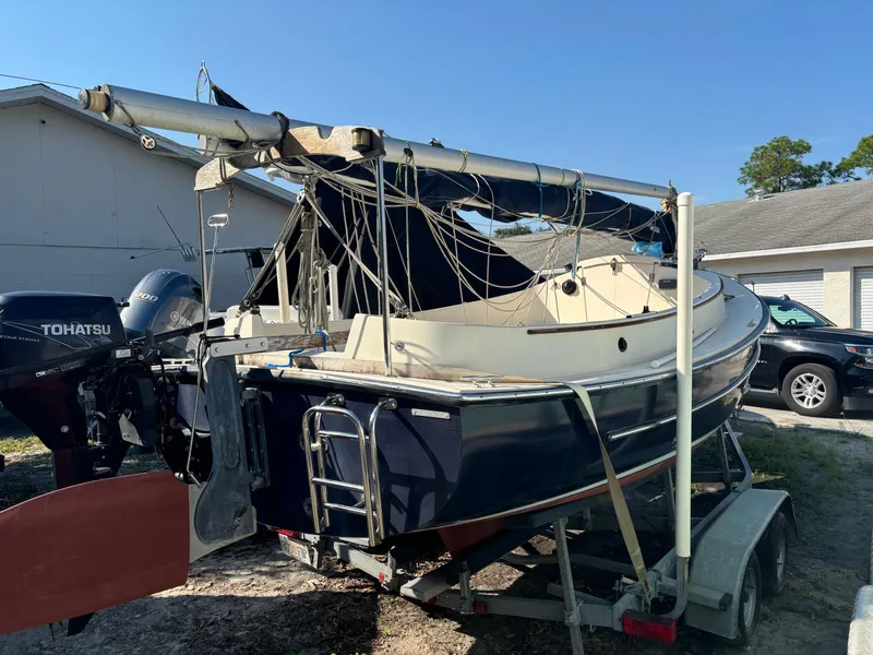 Slide: The Image of 2014 Com-Pac Horizon Day Cat sailboat on trailer with Tohatsu outboard motor. - 3