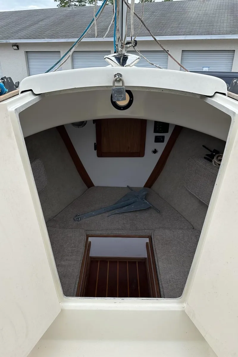 Slide: The Image of 2014 Com-Pac Horizon Day Cat cabin interior with cozy seating and wooden accents. - 7