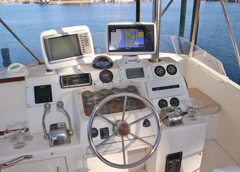 Slide: The Image of Cockpit of 1988 Ocean Yachts 38 Super Sport with navigation equipment and steering wheel. - 10