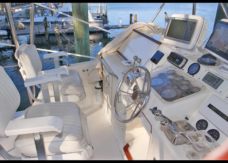 Slide: The Image of Cockpit of 1988 Ocean Yachts 38 Super Sport with steering wheel and navigation equipment. - 11