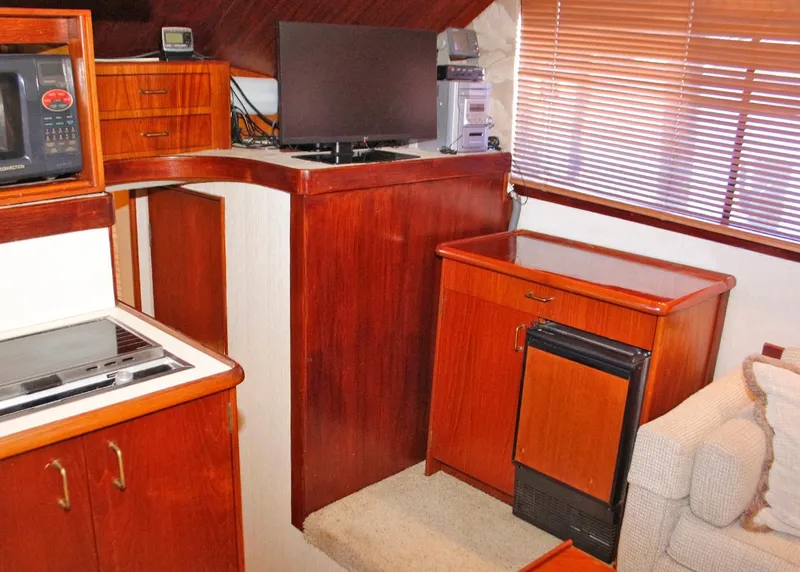 Slide: The Image of Interior of 1988 Ocean Yachts 38 Super Sport with wood cabinetry and modern appliances. - 14