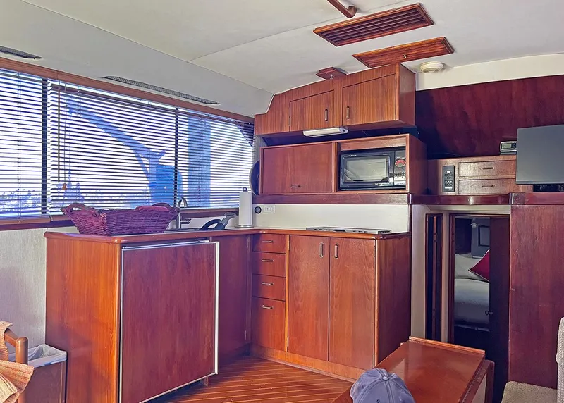 Slide: The Image of Interior of 1988 Ocean Yachts 38 Super Sport with wooden cabinetry and modern amenities. - 15